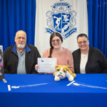 Neff winner with their family at signing