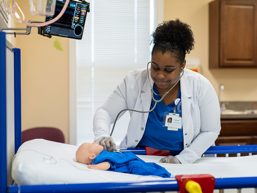 Nursing student practicing on a dummy