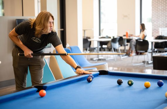 Young man playing billiards