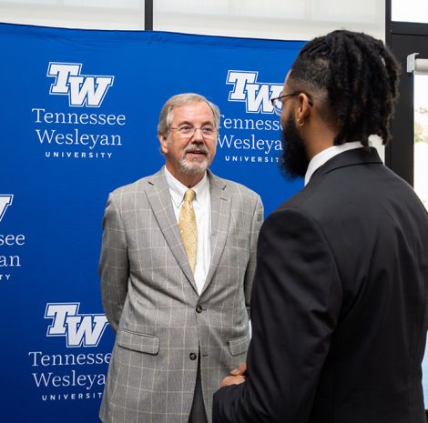 student speaking to a guest in johnson event center